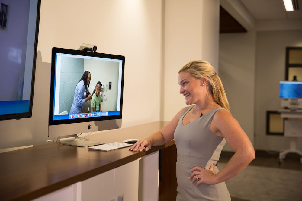 hDr. Kathryn King conducts a demonstration of the MUSC school-based telehealth program with Christian Miley, the school-based health assistant and student Micah Stokes.