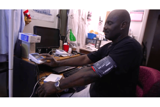 A picture of a man checking his blood pressure.