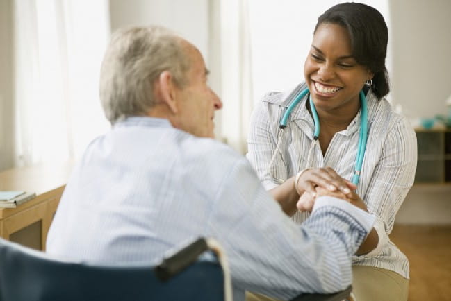 Patient and care giver holding hands