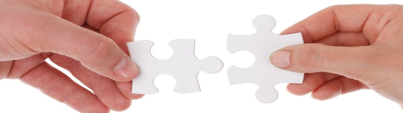 Hands putting together two puzzle pieces